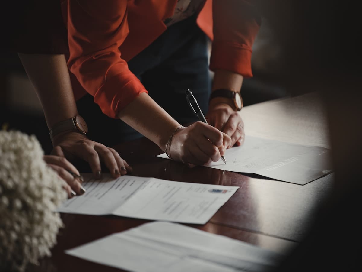 Professional signing an official document.
